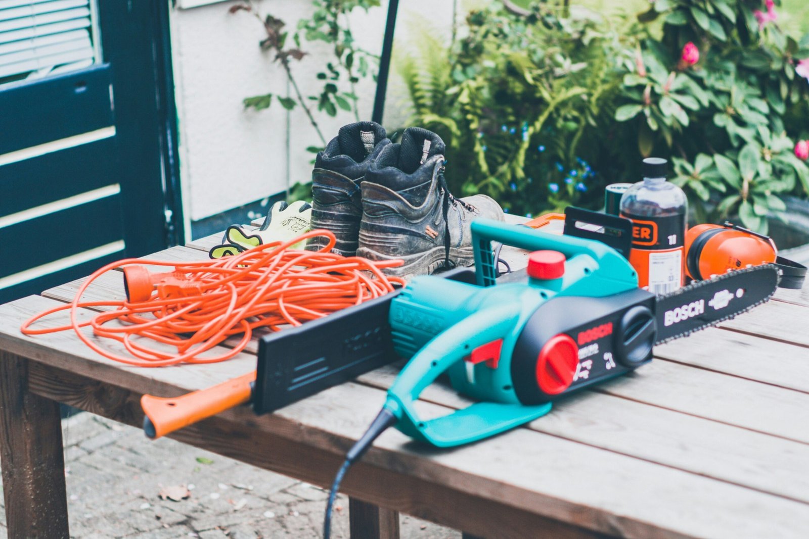 blue Bosch chainsaw on table